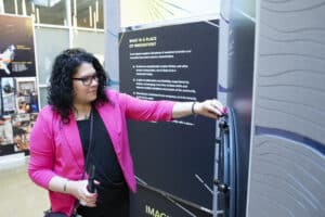 Woman standing in front of exhibit panel