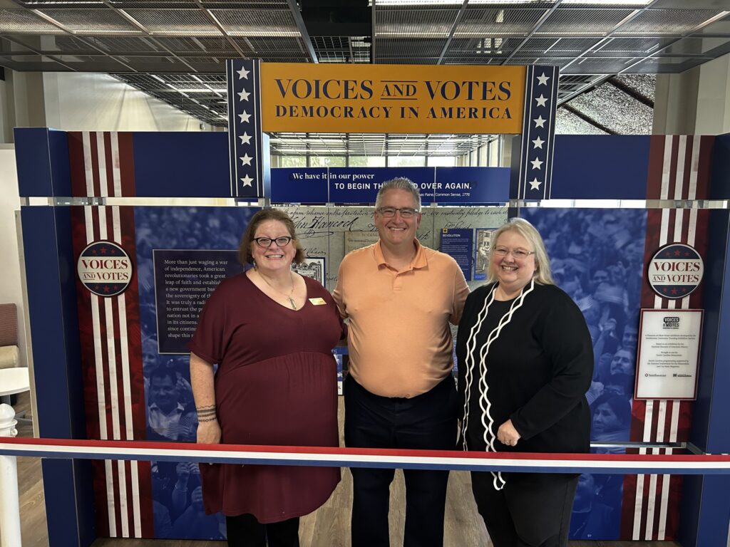 Alamance Community College Opening Event with Three People Standing In Front of the Exhibit